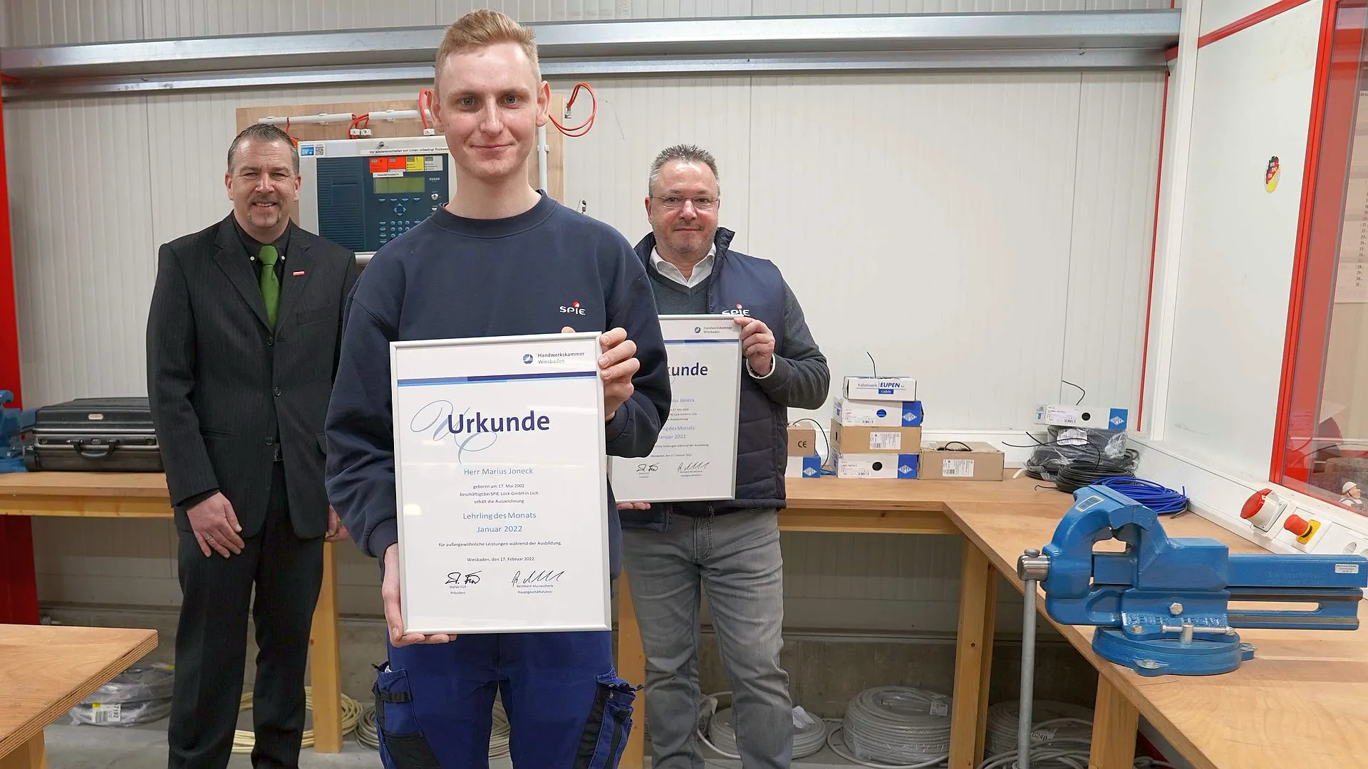 Vorne: Lehrling des Monats Marius Joneck, hinten links: Vizepräsident der Handwerkskammer Wiesbaden Andreas Brieske, hinten rechts: Geschäftsführer der SPIE Lück GmbH Jens Helwin. (Foto: Handwerkskammer Wiesbaden)